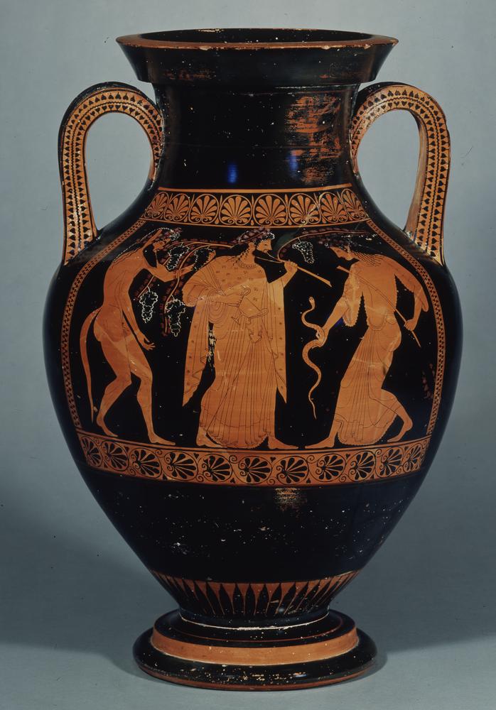 Dionysus, robed and bearded. he wears a crown of vines, and in one hand holds a branch with long vines sprouting from it. A nude satyr stands behind Dionysus, and in front of him is a maenad woman holding a snake.