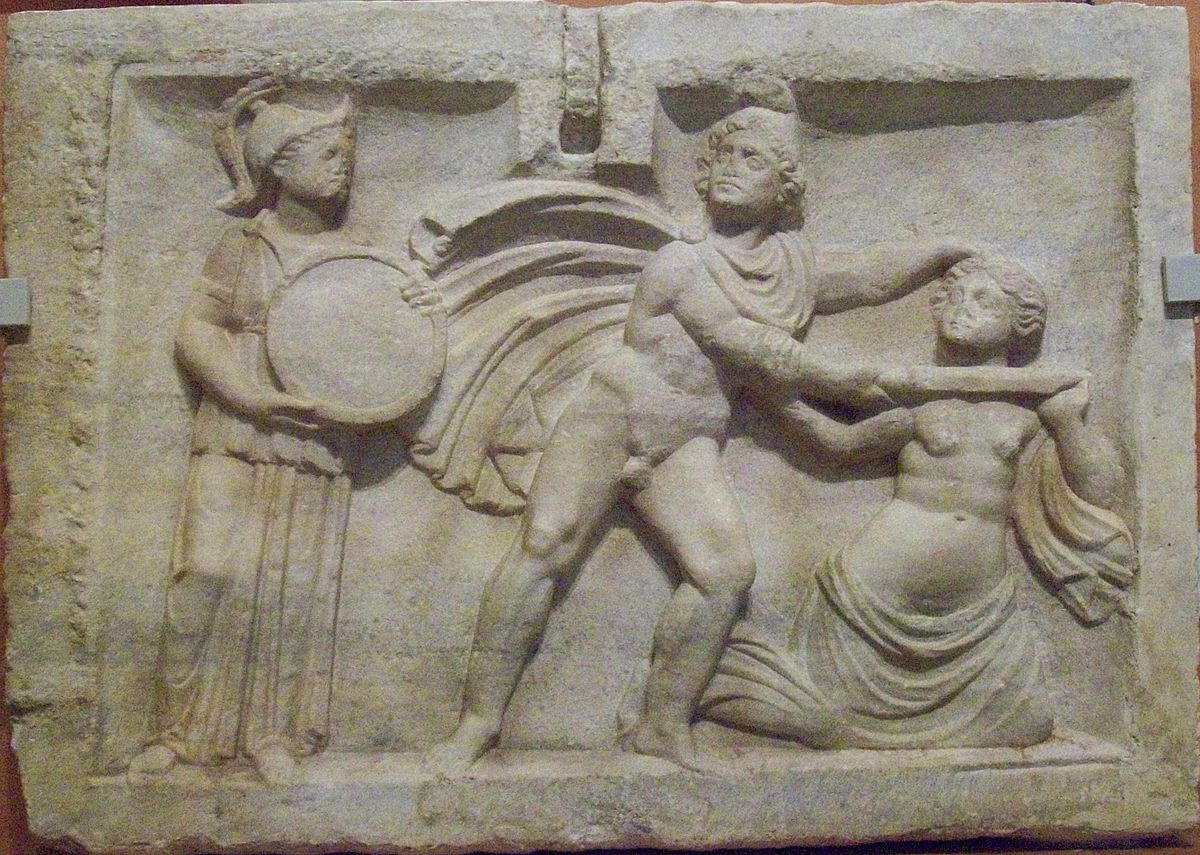 Medusa, a nude young woman, kneels while Perseus holds a sword to her neck. Perseus, wearing a chlamys cape and Phrygian cap, has his head turned to avert his gaze. Behind Perseus stands Athena, holding a mirror.
