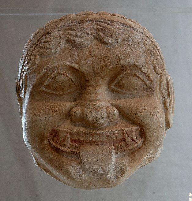 Gorgon head, grinning with her tusks and tongue sticking out.