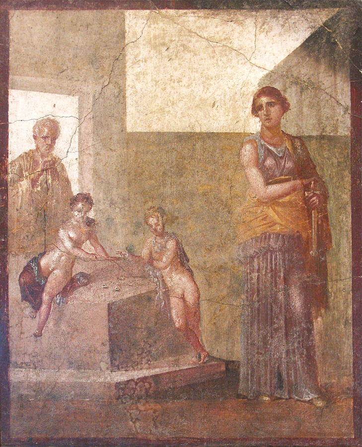 Medea, holding a knife, stands with her back to her family. Behind her, two children are playing, and behind them is an elderly Jason.