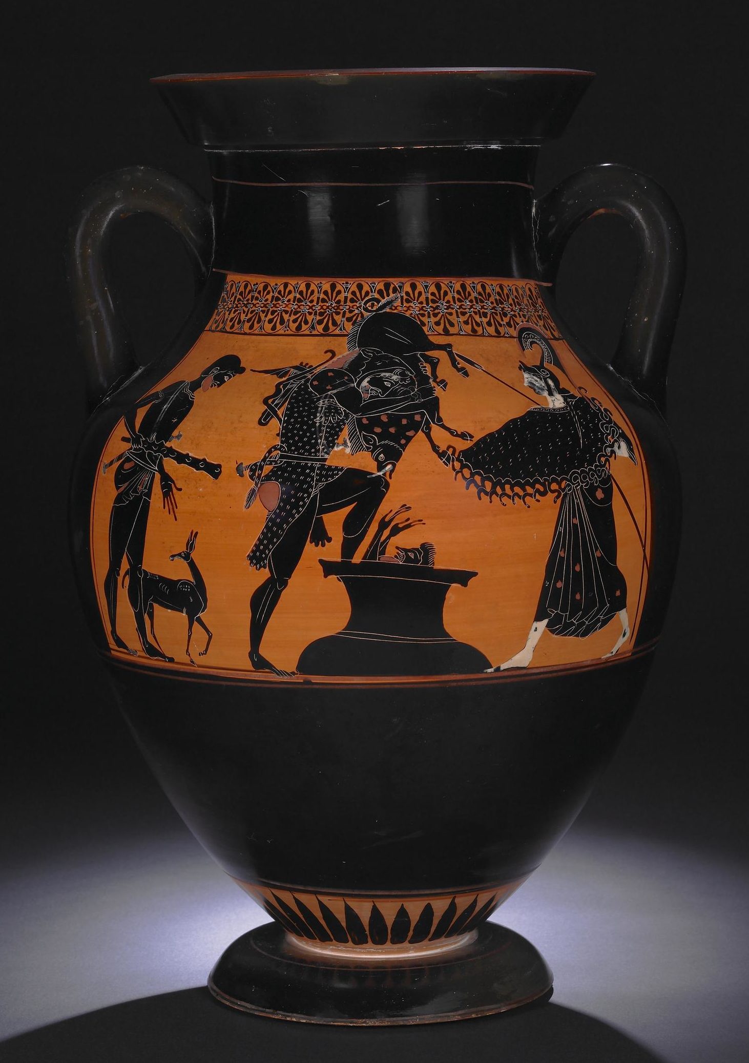 Heracles, holding the boar, stands with one foot on the rim of a pot that is set into the ground. Eurystheus hides in the pot, his arms and head sticking out, as Heracles drops the boar down on him. Iolaus stands behind Heracles with a deer at his feet and holding Heracles' club, and Athena stands to the right.
