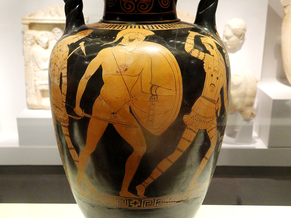 Theseus, nude with a shield, helm, and sword, pursues an Amazon. Another Amazon attacks him from behind. The amazons wear short armored tunics and wield picks, and are depicted with jagged tiger-like stripes on their arms and legs.