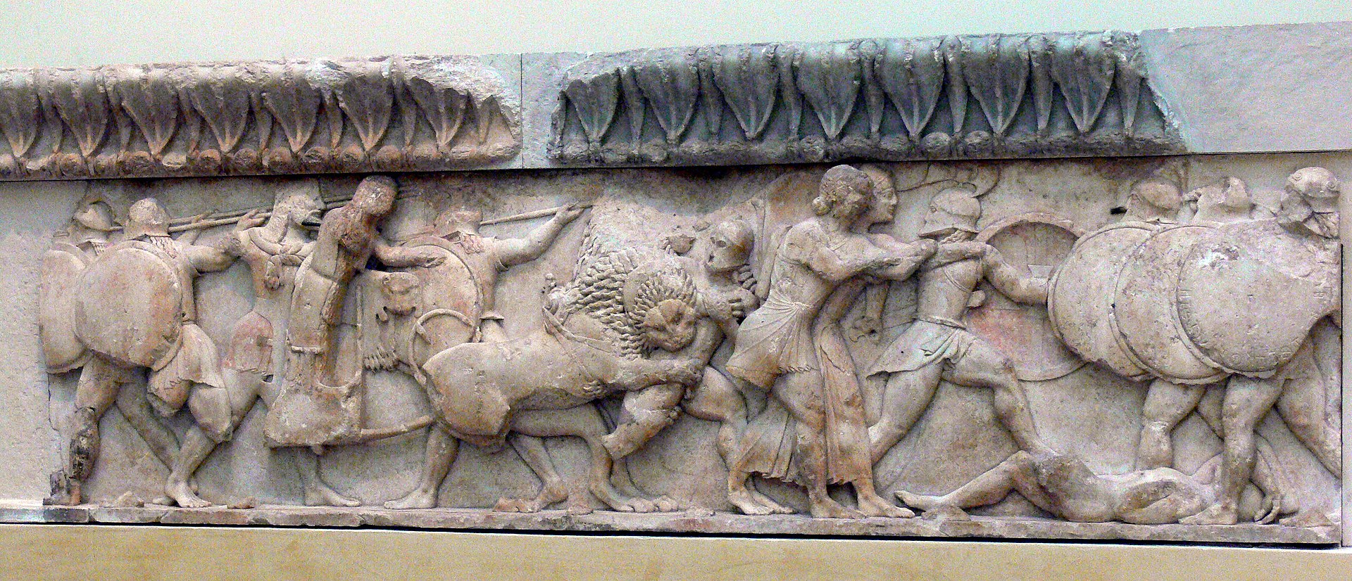 Gods and giants, armed with round shields and spears, fight. A large lion is in the melee.