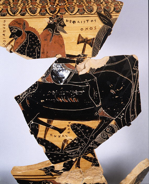 Hephaestus, crowned and holding a hammer, rides on a mule. A fragmentary satyr follows behind.