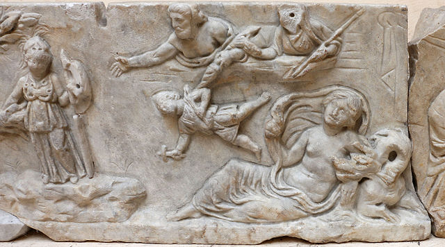 Zeus and Hera, up on a ledge, reach out and throw down Hephaestus. Hephaestus is a child in a conical hat and holding a small hammer. Athena stands by. Below, a woman, likely Thetis, reclines beside a sea monster.