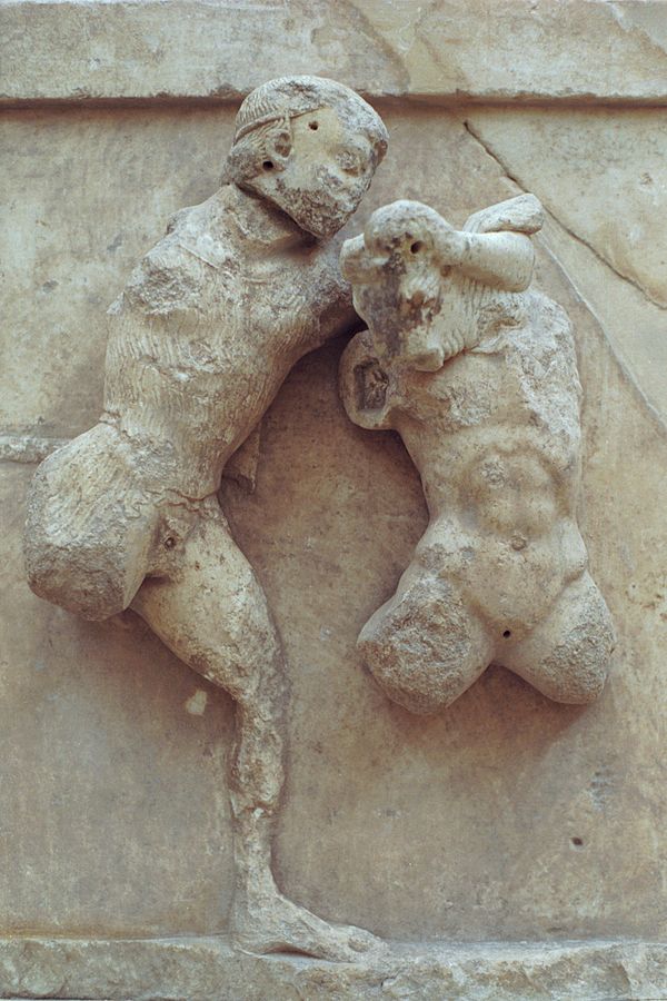 Theseus holds the minotaur in a headlock. Both figures are heavily damaged.
