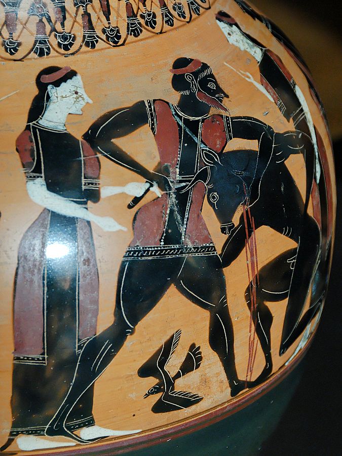Theseus, in a tunic and hat, holds the Minotaur in a headlock and stabs at it. Blood pours from the wound. Two young women stand on either side, and a bird flies below Theseus.