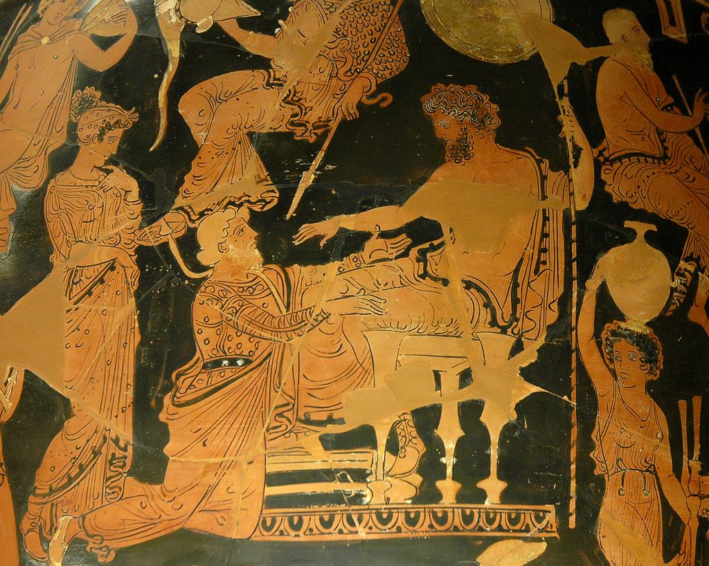 Agamemnon sits on a throne, holding a spear and wearing a himation. Chryses, in elaborate robes, kneels before Agamemnon and grabs at his knees. Other figures stand and sit around the scene.