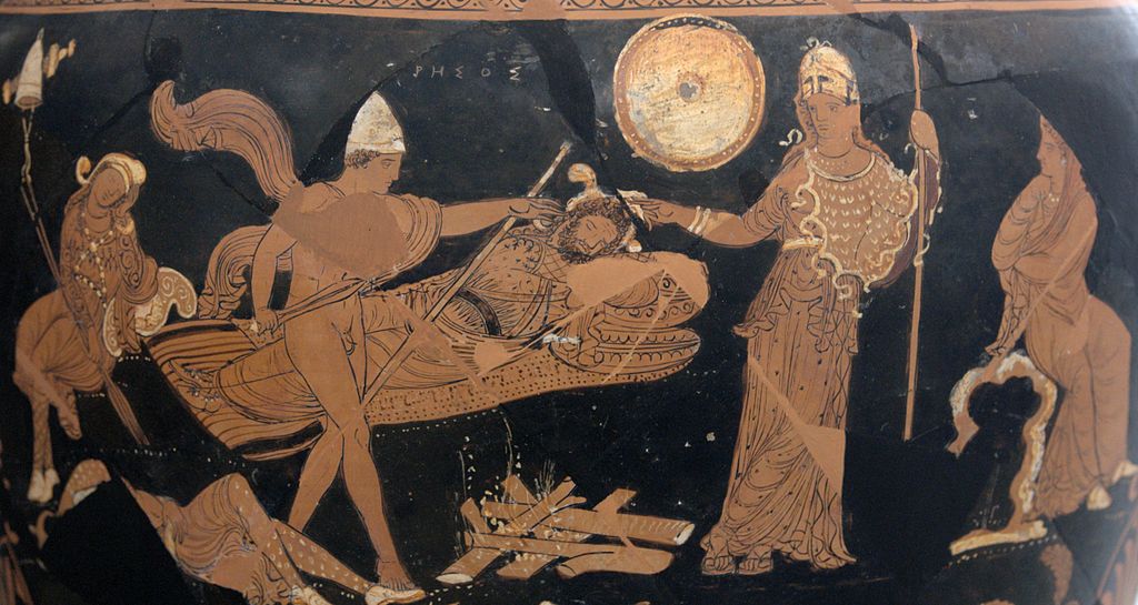 Diomedes, in chlamys cape and conical Phrygian cap, holds a knife and reaches out to stab the sleeping rhesus. A Thracian lies dead on the ground behind Diomedes, and Athena stands by. Two seated women frame the scene on either side.