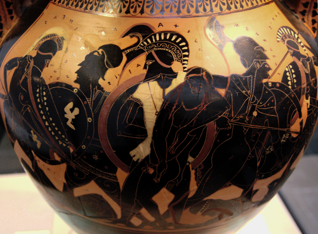 Ajax, with helm, armour, and shield, carries the nude body of Achilles under one arme. Other warriors with arms and armour surround them on either side.