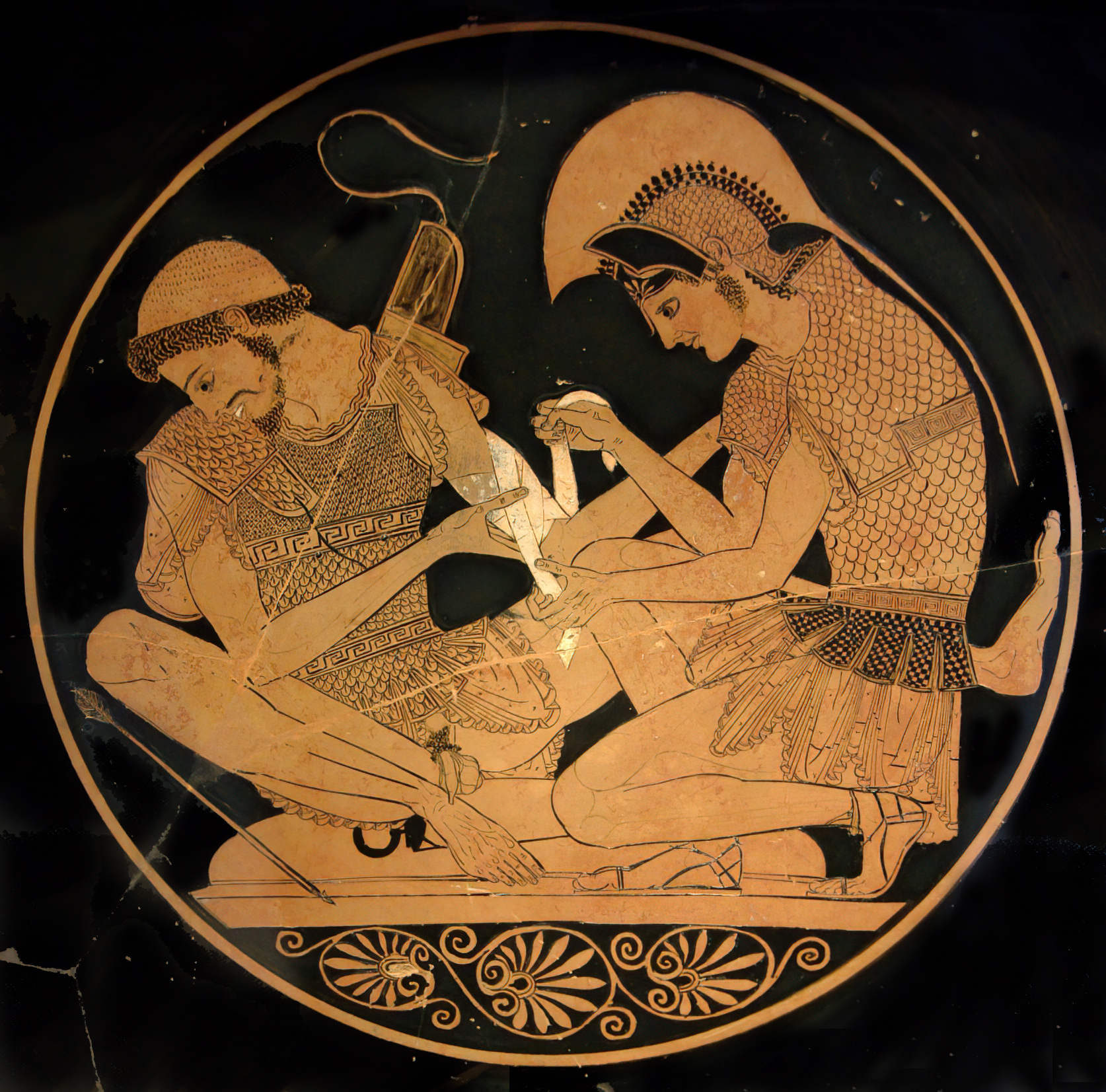 Achilles, youthful and wearing a plumed helm and armour, sits and bandages the arm of Patroclus. Patroclus wears armour and a rounded cap, and is bearded.
