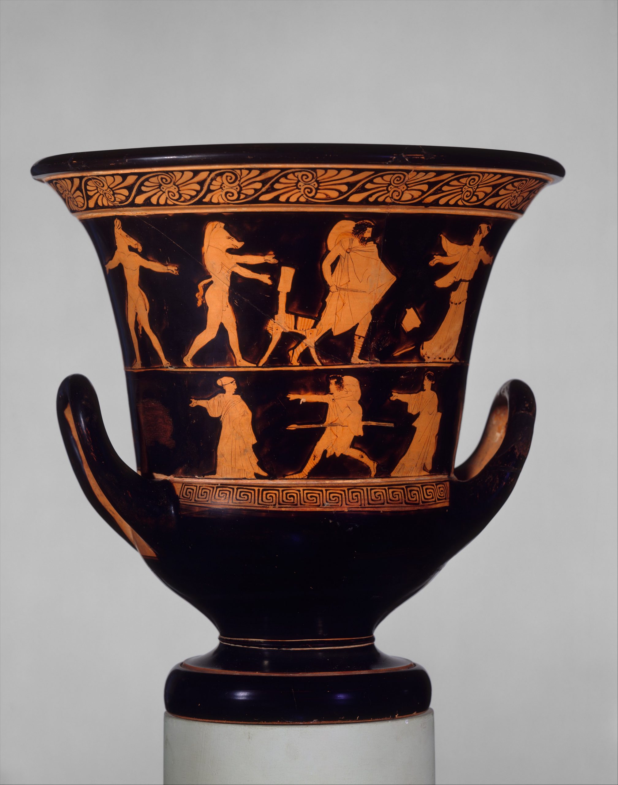 Odysseus, in a chlamys cape with a petasos hat around his neck, chases Circe with a knife. Circe, in billowing robes and a head wrap, flees. Behind Odysseus are two nude men with the heads and tales of boars. The bottom row of the krater shows a young man and two women running.