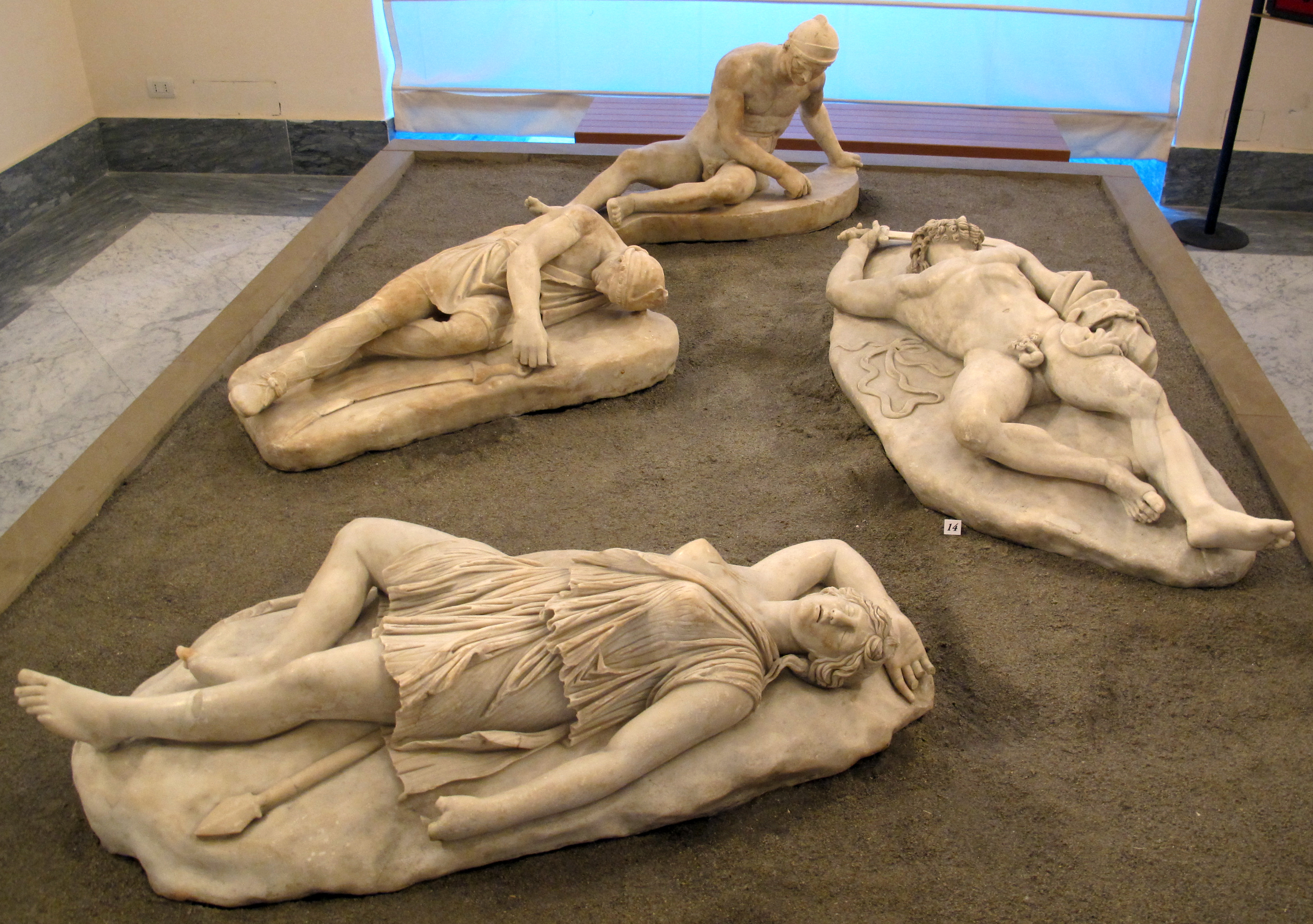 Four statues of wounded figures lying on the ground: an Amazon, a Giant, a Persian, and a Galatian