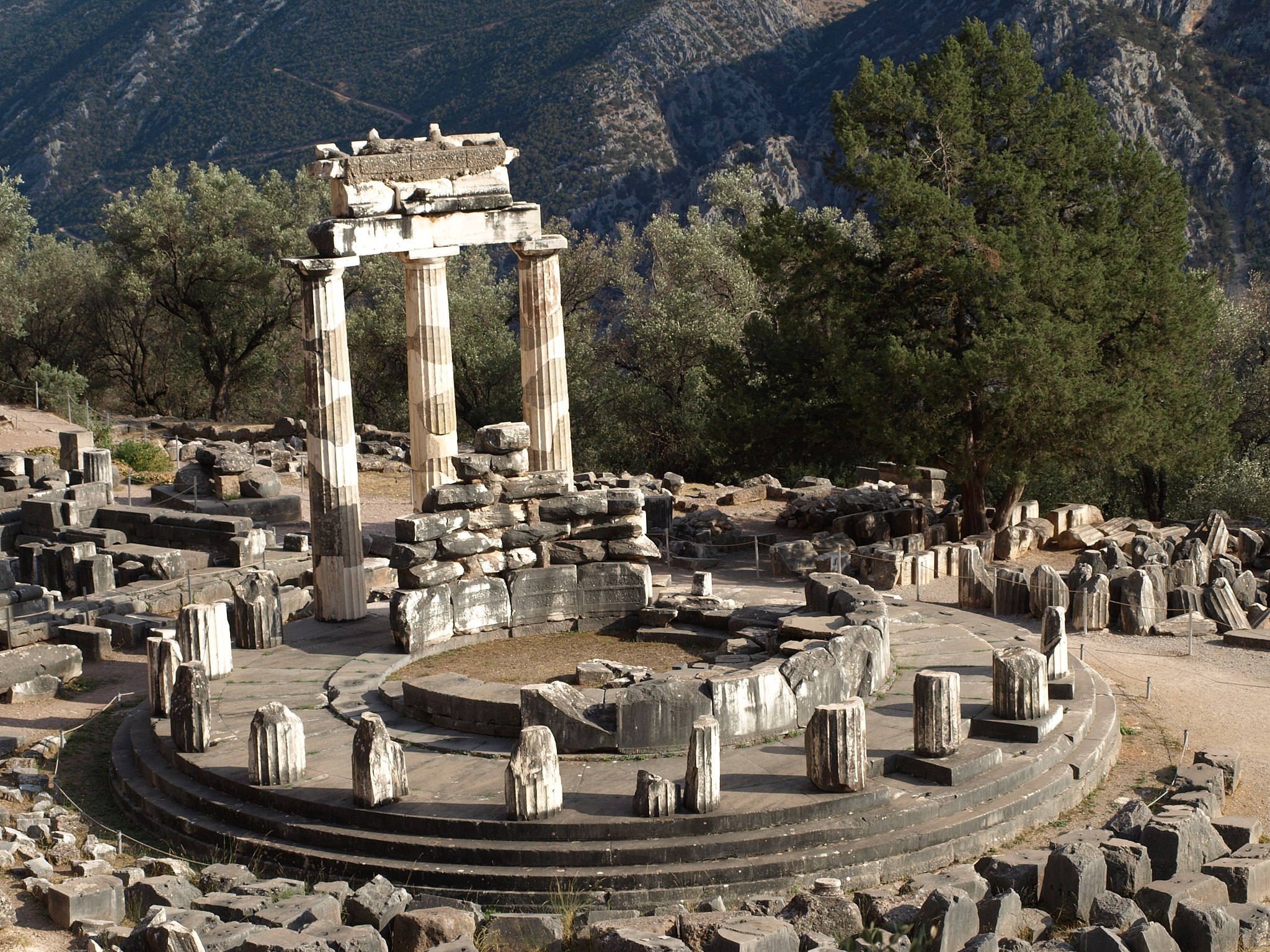 Stone archaeological remains, with reconstructed portions, of the Athena pronaia. The temple comprises a circular inner chamber with a circle of columns around it, three of which are reconstructed.