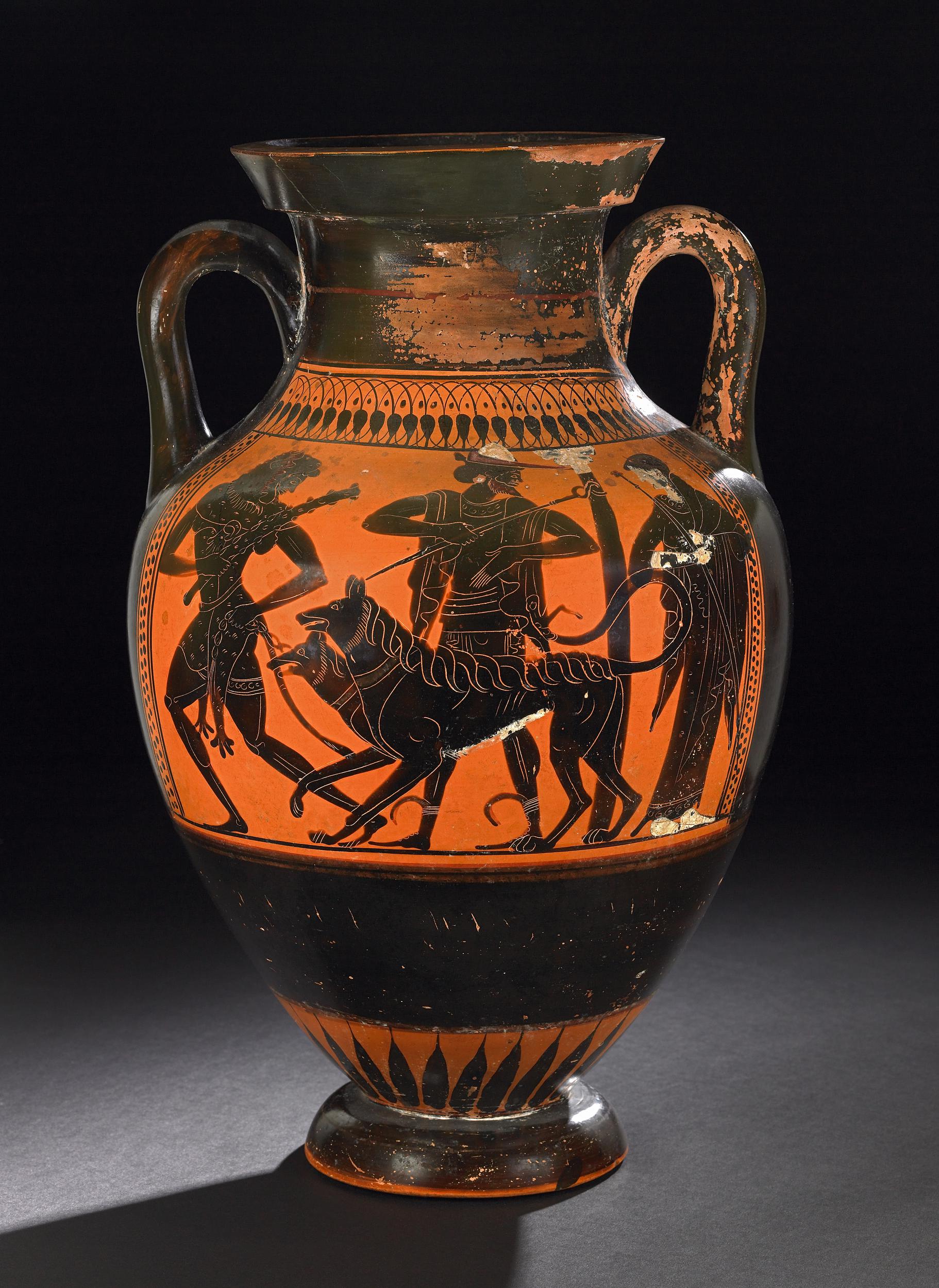 Heracles, carrying a club and wearing his lion skin, leads the three-headed dog Cerberus on a leash. Hermes, with petasos hat and cadduceus, stands beside Cerberus. Persephone, in decorated robes and holding a sceptre, stands to the right.
