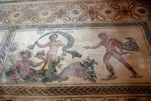 Apollo, wearing hunting boots and a short cloak, runs towards Daphne whose legs have started turning into a tree trunk. Her father, the river Peneus, in the shape of a bearded man holding a cornucopia, reclines at her feet.