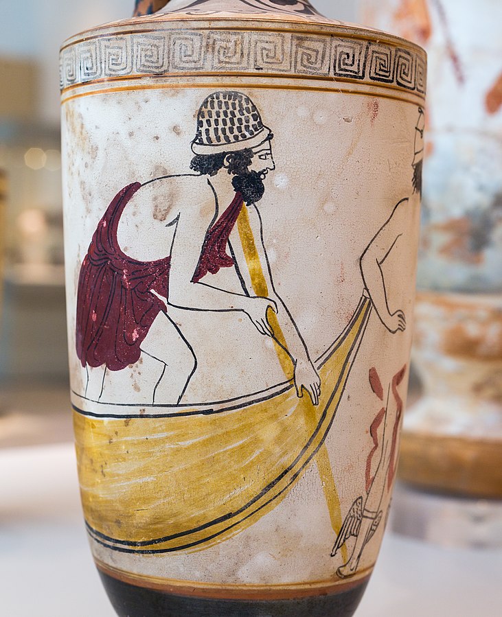 Charon, in a hat and red tunic, stands on a barge, leaning over the side with a punting pole. Around the side of the lekythos, Hermes stands with his winged sandals.
