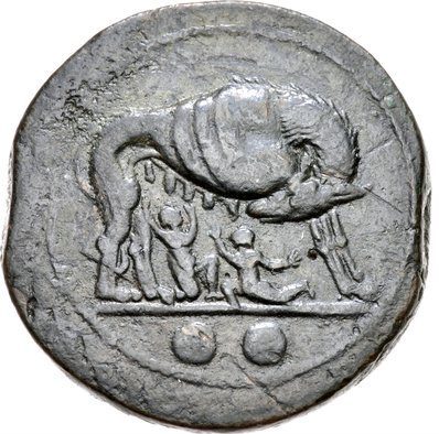 One side of a coin. Small, child figures of Romulus and Remus under the belly of a she-wolf. Both children are down on one knee and reaching up towards the wolf's teats. The wolf stands with her head turned to look at the two children.