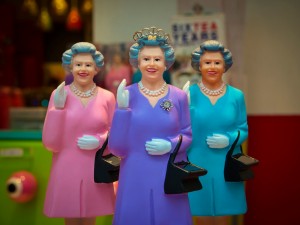 Three toy replicas of Queen Elizabeth II.
