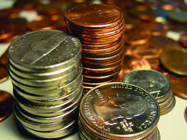 A photo of coins; separate stacks of nickels, pennies, quarters, and dimes