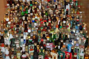 This picture shows a large variety of bottles of alcohol.