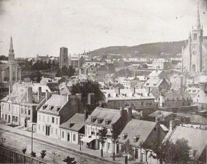 A picture of Montreal. St. Patrick's Cathedral towers over all of the other buildings around it.