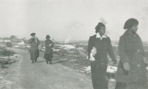 Figure 6.7 Women from Africville walk towards Halifax on Campbell Road, days after the explosion of the SS Mont Blanc in Halifax harbour on 6 December 1917. The ship was carrying munitions when it was struck at low speed by another vessel, caught fire, and produced the largest pre-nuclear explosion on record, killing 2,000 and injuring 10,000 more. Photo by James & Son, Nova Scotia Archives. https://www.flickr.com/photos/nsarchives/15318268313/in/album-72157649578567872/