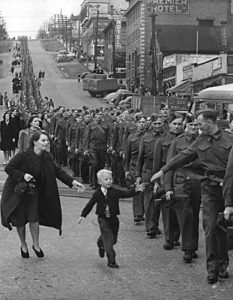 A British Columbian regiment prepares to depart from New Westminster, 1940. ("Wait for me daddy" by Claude Dettloff, photographer - City of Vancouver Archives online database, Public Domain, https://commons.wikimedia.org/w/index.php?curid=4210431)