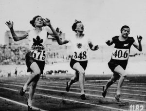 Myrtle Cook crosses the line first in a 100 m heat at the 1928 Olympics.