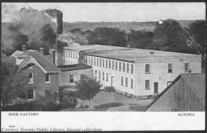 As late as 1910 the boundary between rural life and industrial employment was not a great one. The countryside forms a backdrop to a shoe factory in Aurora, Ontario, ca. 1910. Postcards like this one were a way of framing modernization and material progress. (Toronto Public Library) https://www.flickr.com/photos/43021516@N06/5436281688