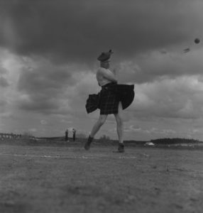 The survival of amateurism in sports narrowed to events like the 1940 Highland Games in Antigonish. A kilted stone-thrower in action.