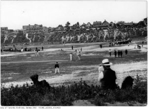 Parallel universes. Amateur cricket in the foreground and baseball -- a game at which one could make money -- being played in Willowvale Park (now Christie Pits), Toronto, 1920.