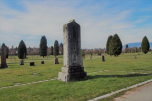 A photograph of a tall stupa with Japanese inscriptions at Vancouver's Mountain View cemetery.