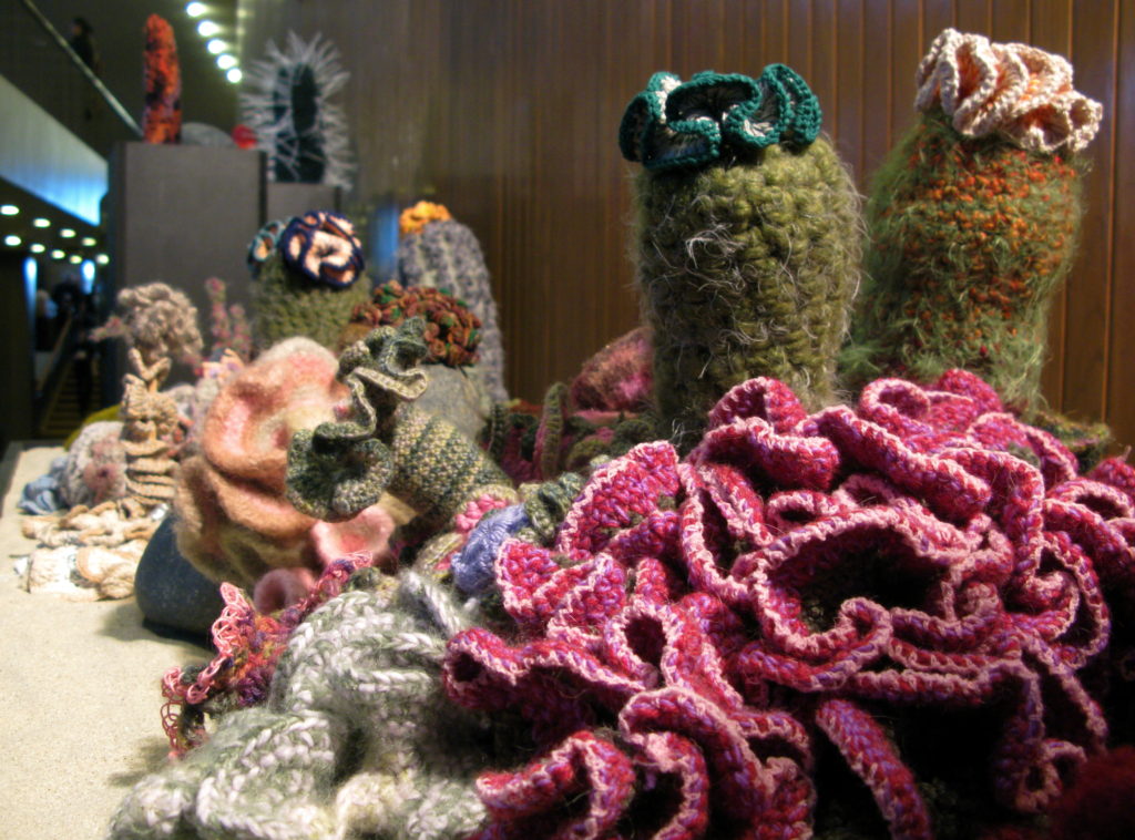 A coral reef crocheted from yarn in a variety of colours and shapes.