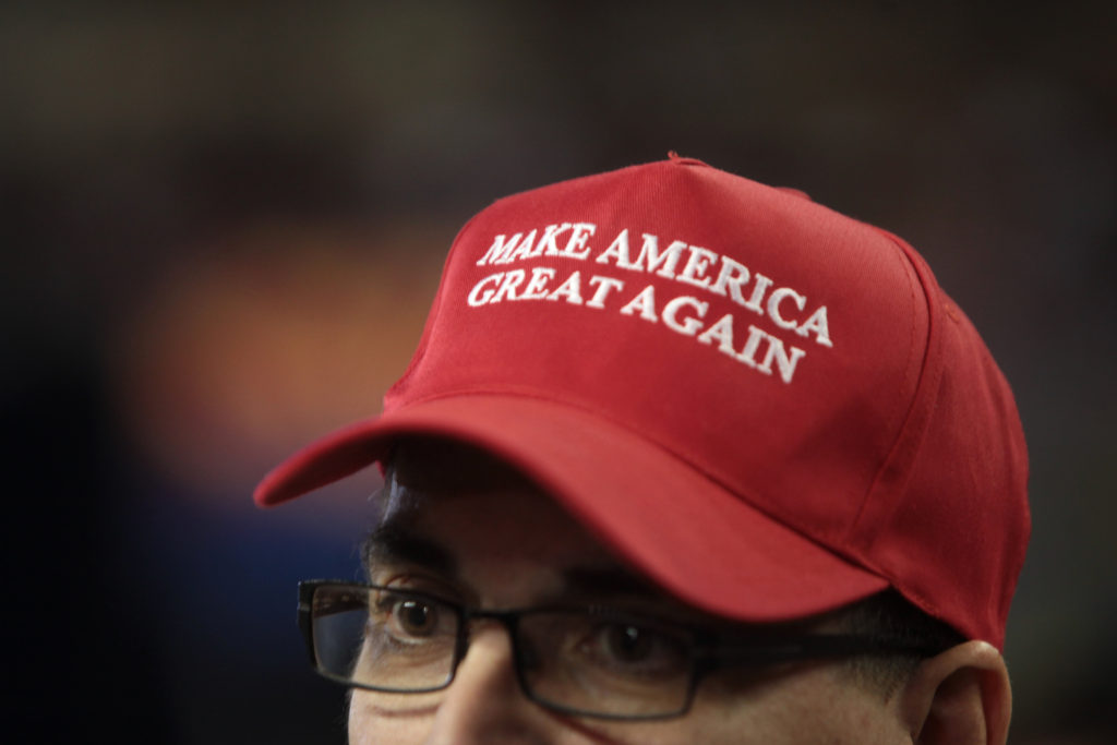 Man wearing a red hat with the slogan 'Make America Great Again."