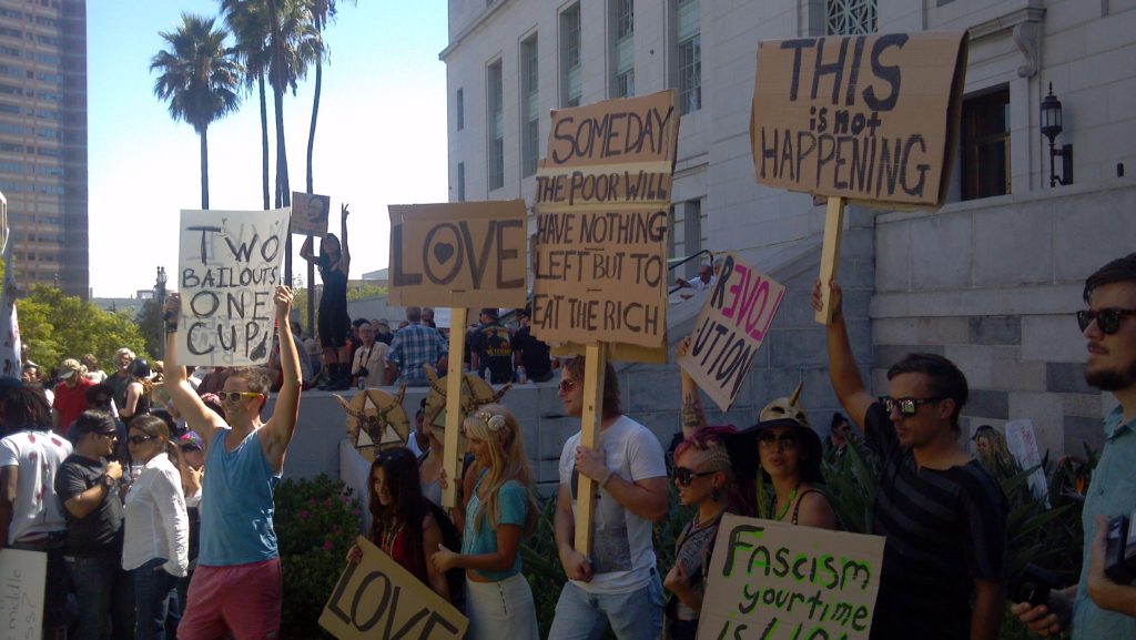 Activists protesting outdoors with placards.