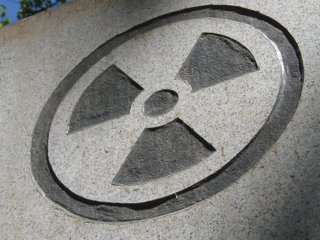 Radioactive waste symbol etched into stone.