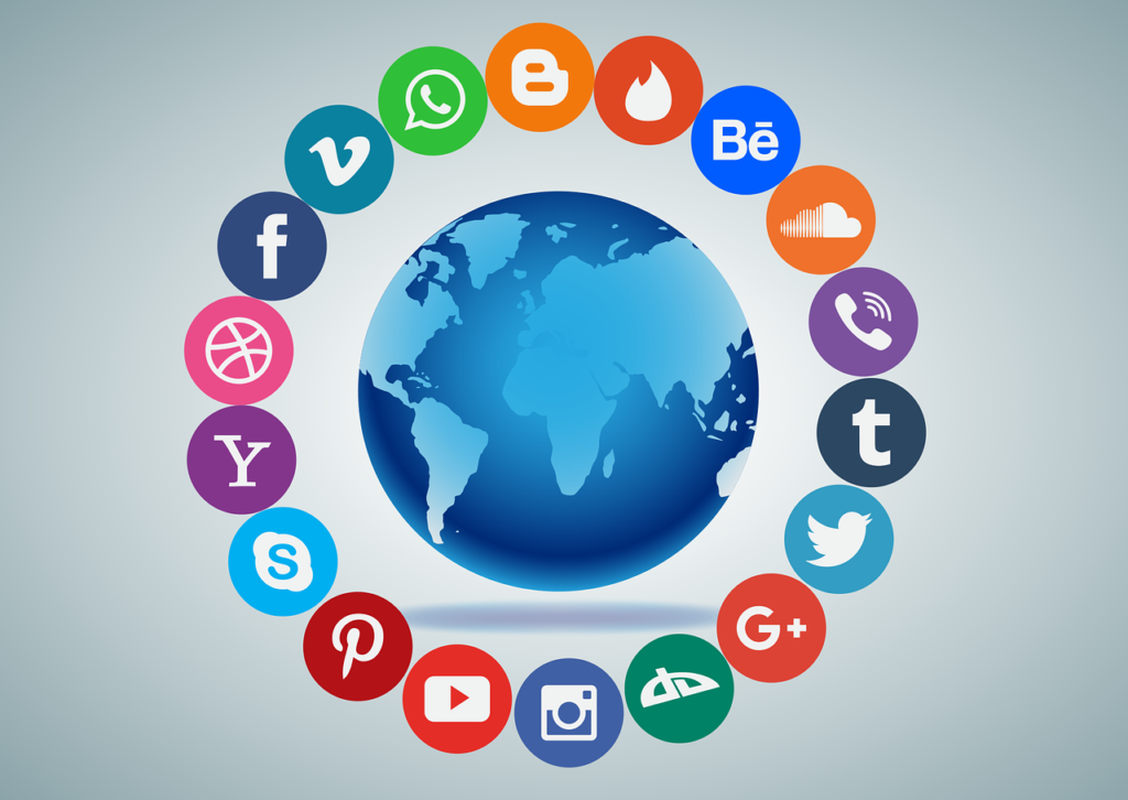 An image of the world is surrounded by social media logos (i.e., Facebook logo, Twitter logo etc.).