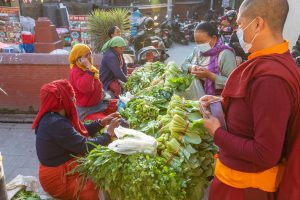 Vendors and shoppers at a street vegetable market in Kathmandu, Nepal.