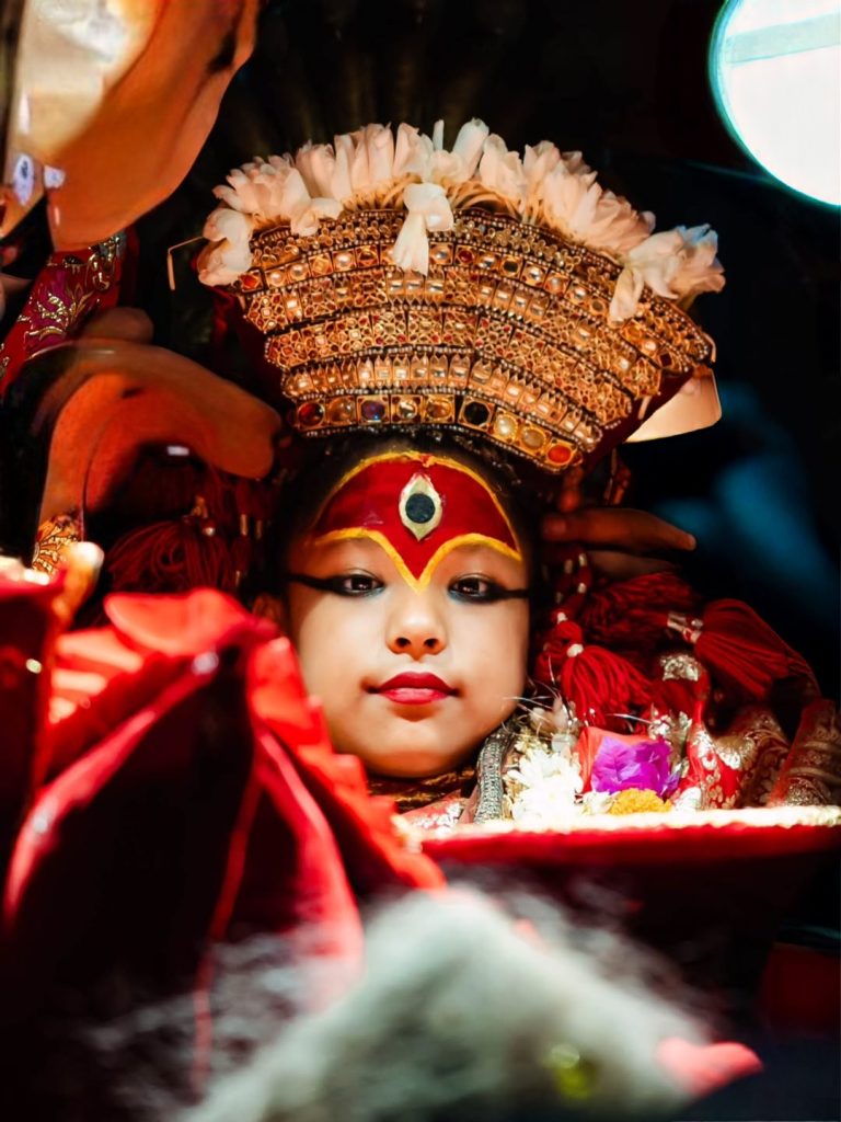 Former Royal Kumari Trishna Shakya in traditional attire and ceremonial makeup.