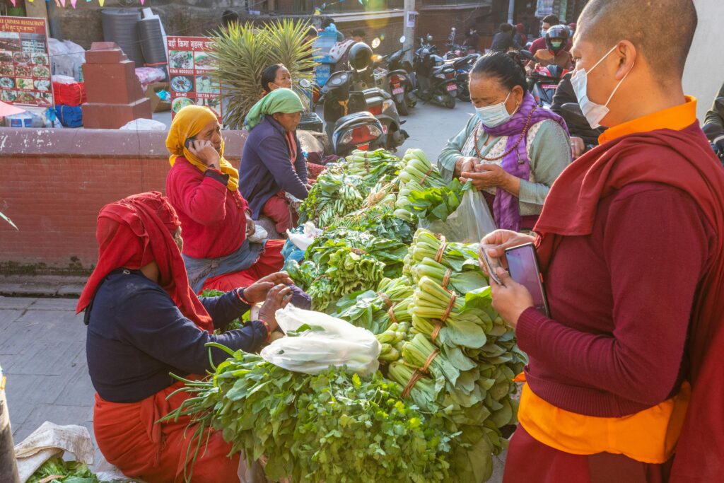 Vendors and shoppers at a street vegetable market in Kathmandu, Nepal.