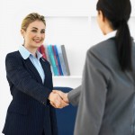 A salesperson and a customer shaking hands