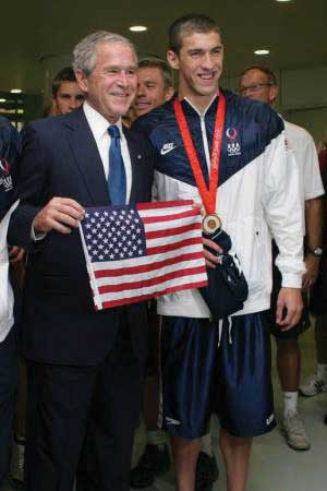 Micheal Phelps standing next to George Bush