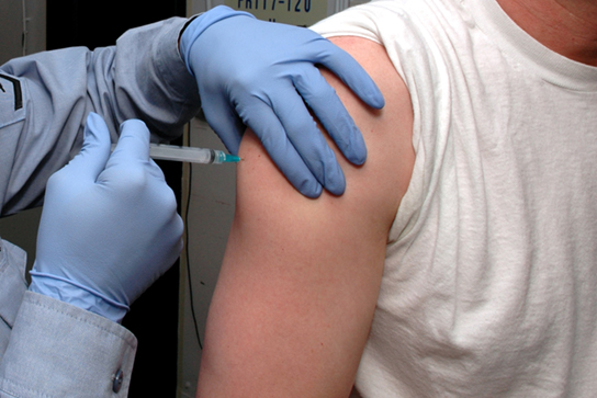 Image showing a man receiving a Hepatitis-B vaccine shot intramuscularly.
