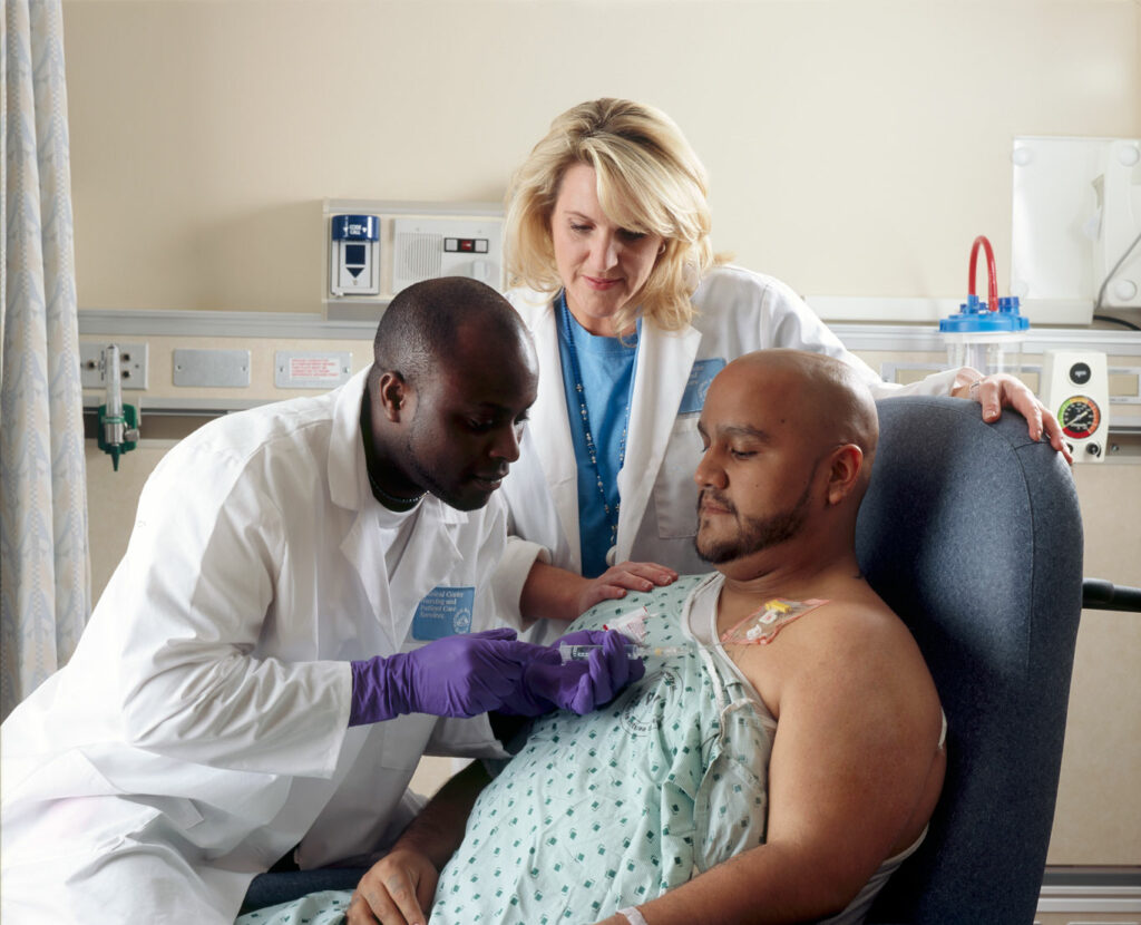 Patient receives chemotherapy drug treatment through a port that is placed in his chest. In addition to their use in cancer treatment, chemotherapy drugs can be administered in low doses to help suppress an overactive immune system.