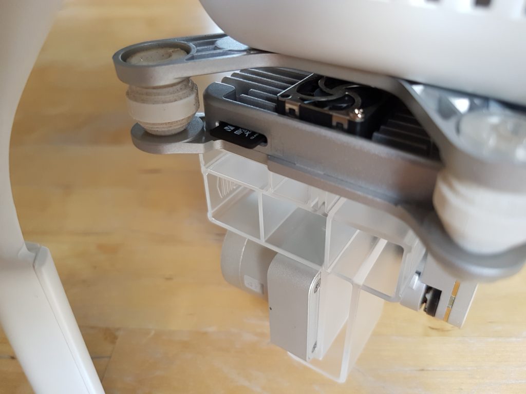 Photo of a white DJI Phantom 3 Professional showing MicroSD card memory card slot