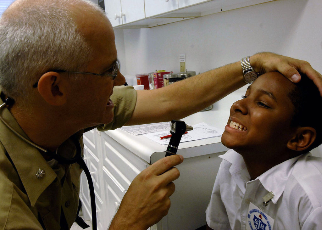 A pediatrician making a child smile