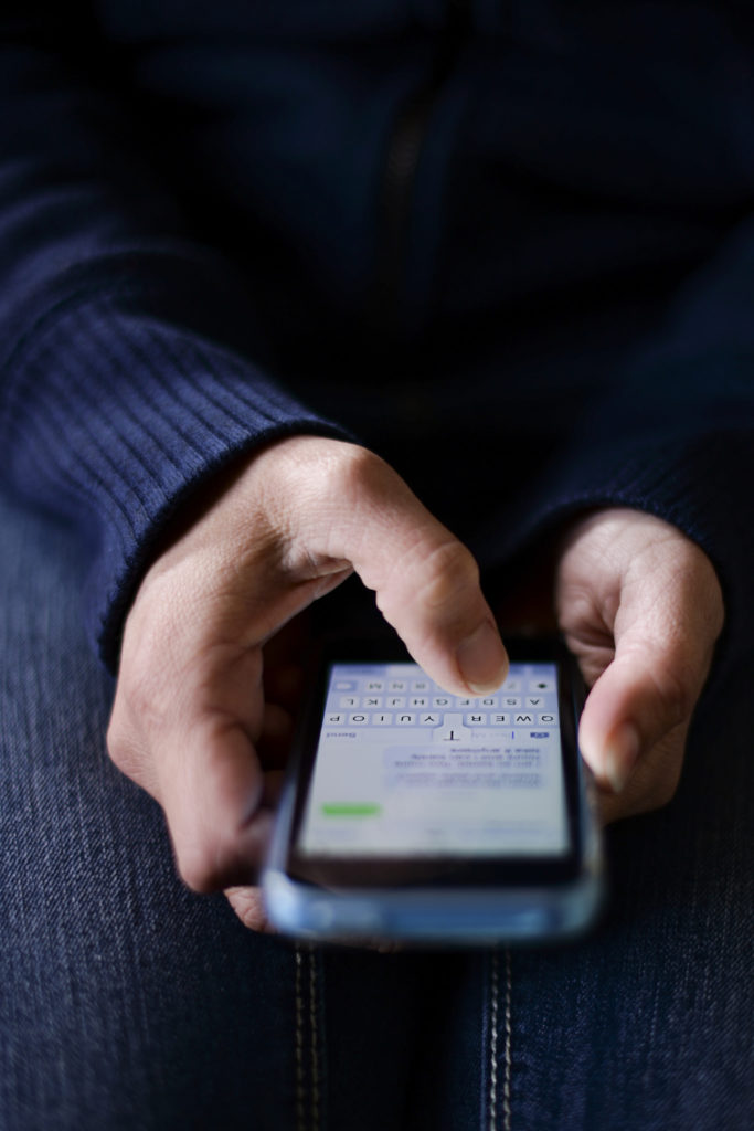 A man texting on his iPhone