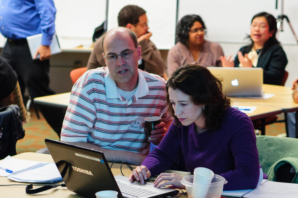 Computer Science DBES with faculty member at a laptop.