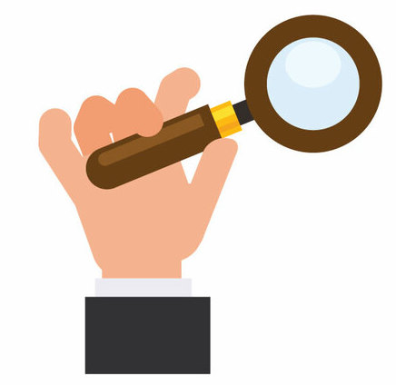 Hand holding a magnifying glass